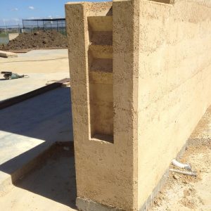 Rammed earth wall by Olnee